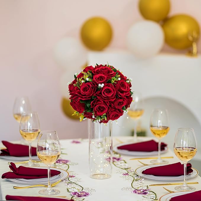 Decorative table setting with red roses, wine glasses, and balloons.