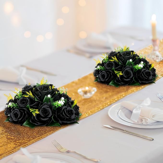 Decorative table setting with black roses and gold runner.