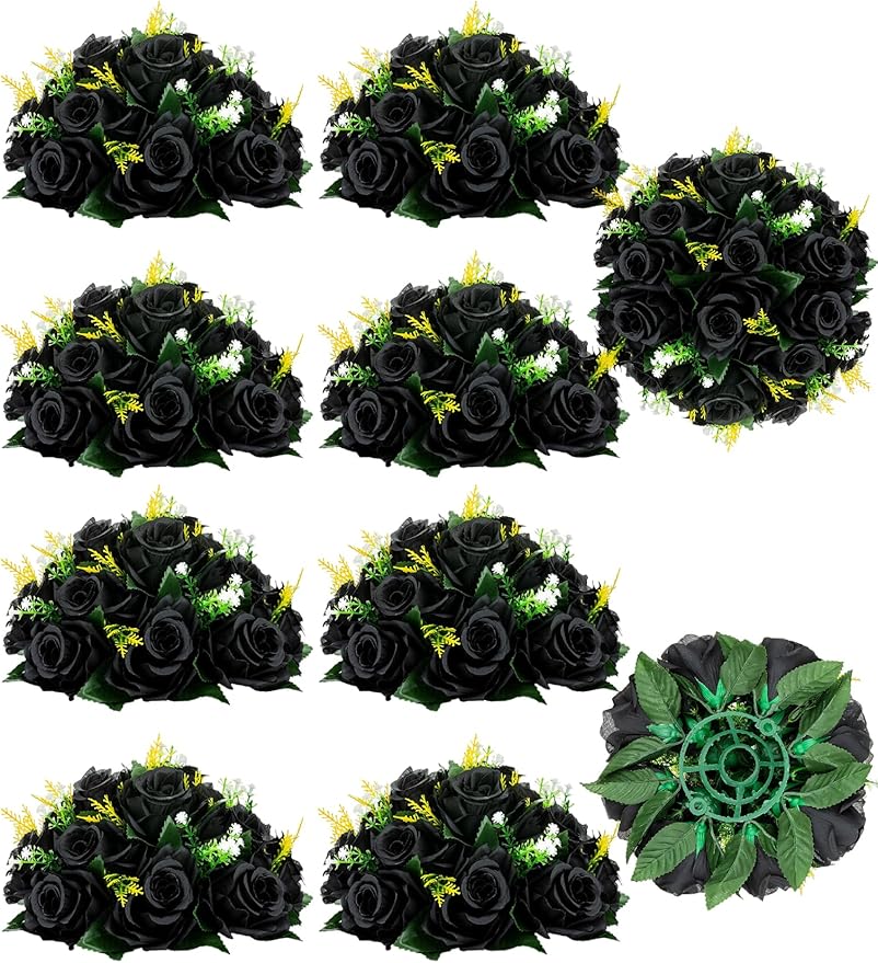 Set of black artificial roses and green leaves on a white background